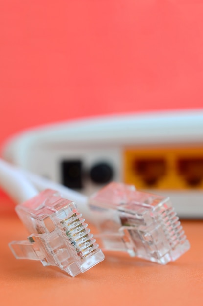 Internet router and Internet cable plugs lie on a bright orange background. Items required for Internet connection