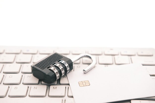 Internet safety concept with padlocked and credit card on\
computer keyboard