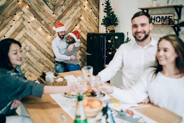 Interracial couple celebrating Christmas with friends