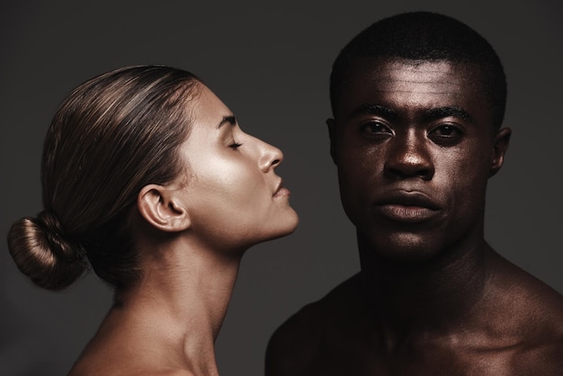 Interracial couple face or love in skincare dermatology or beauty as health support or wellness Black man woman or glow as creative aesthetic or diversity in bonding together on grey background