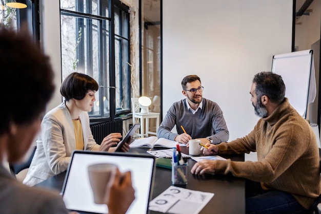 An interracial team collaborating on a project at boardroom