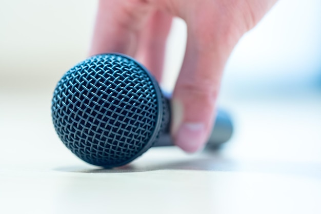 Interview Journalist is holding a microphone in his hand Close up