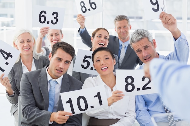 Interview panel holding score cards in office