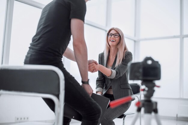 Interviewer welcomes the guest to the Studio