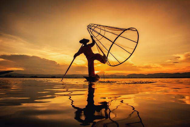 Intha Burmese fishermen on boat catching fish traditional at Inle Lake, Shan State, Myanmar