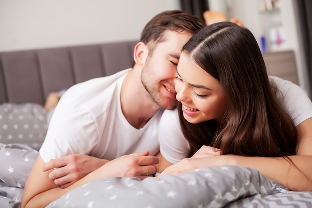 Photo intimate sensual young couple in bedroom enjoying each other