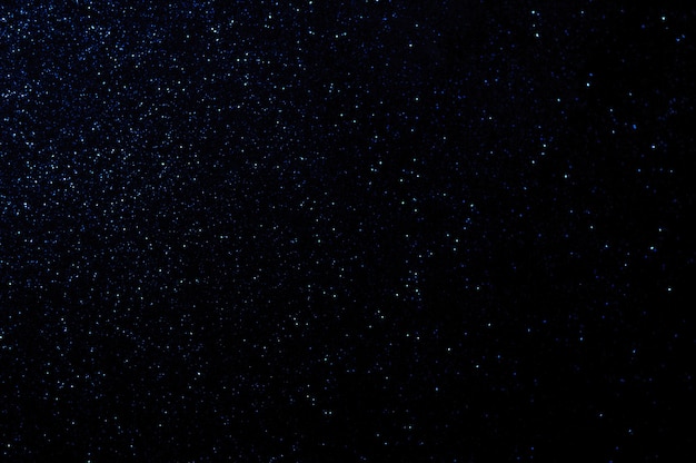 Intreepupil blauwe lichten glanzende deeltjes ruimte sterren abstracte achtergrond
