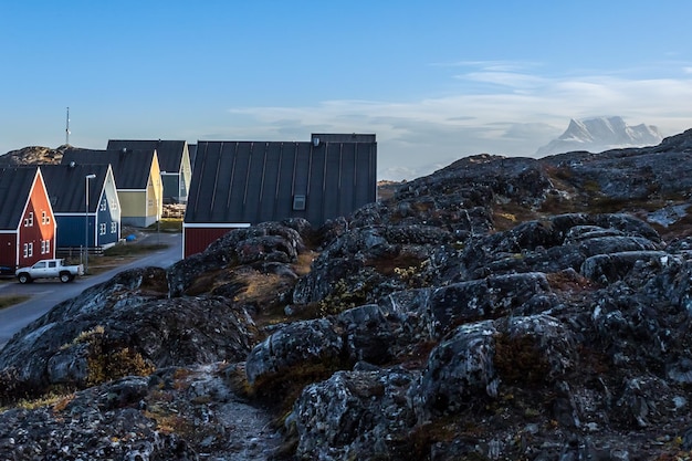 Inuit houses along the street hidden in stones with Sermitsiaq mountain in the background Nuuk Greenland