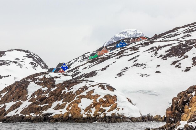 Inuit houses hidden among the rocks at the rocky fjord in the middle of nowhere Kangamiut Greenland