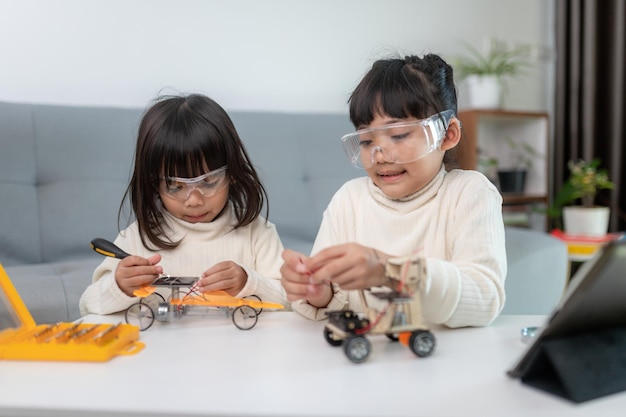 Inventive kid constructing robot cars at home