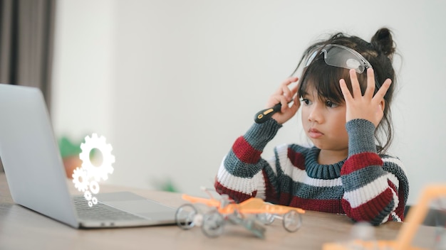 Inventive kid constructing robot cars at home