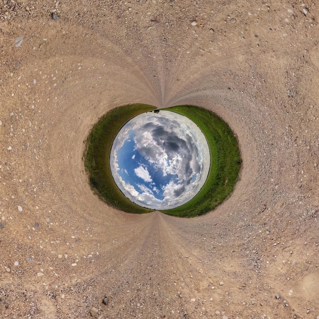 Inversion of blue little planet transformation of spherical panorama 360 degrees Spherical abstract aerial view on road with awesome beautiful clouds Curvature of space