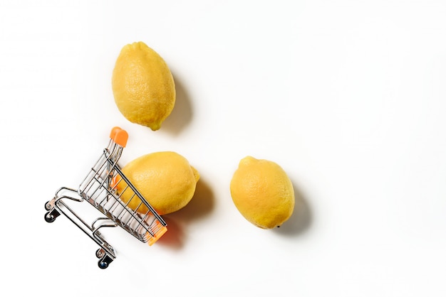 Inverted supermarket cart with three lemons