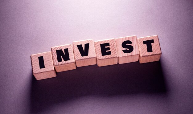 Invest Word Written on Wooden Cubes