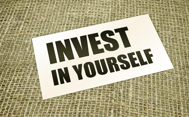 Photo invest in yourself words on card on burlap canvas business education concept