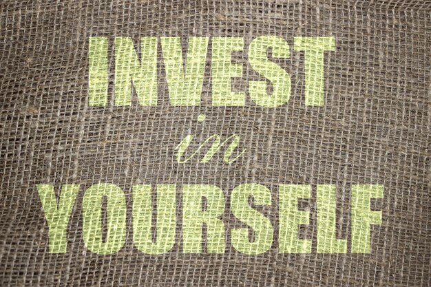 invest in yourself words printed on burlap canvas business and career concept for self motivation