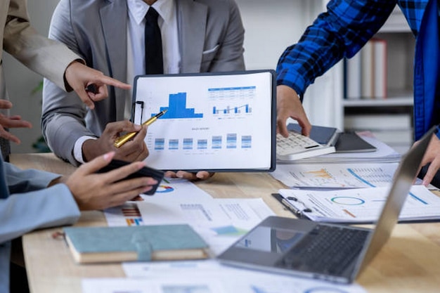 Investment Consultant Asian business adviser meeting to analyze and discuss the situation on the financial report in the meeting desk office Financial advisor and accounting concept