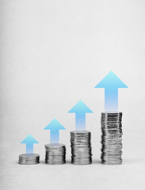 Investment growth financial business Increase earnings money passive income and sales profit concept Rising up blue arrows on coin stack growth graph chart step on isolated on white background