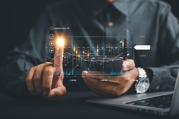 Investment planning and strategy concept Trader man points at a virtual hologram stock on a screen symbolizing the possibilities of stock market trading for business growth and financial success