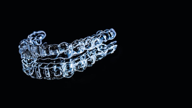 Invisible aligners teeth retainers lie on the mirror