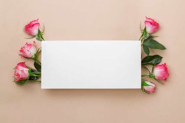 Invitation or greeting card mockup with blank paper and pink rose on a beige background