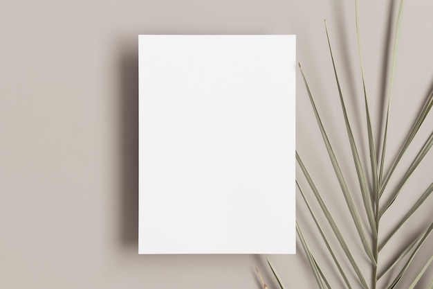 Photo invitation white card mockup with a palm leaf on a beige table 5x7 ratio similar to a6 a5