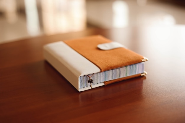 Invitations, notepad, handmade notebook on the wooden table.