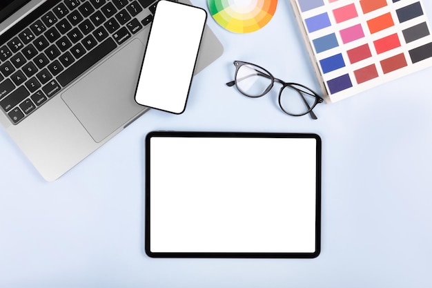 ipad pro with white screen on white color background. flatlay. office background