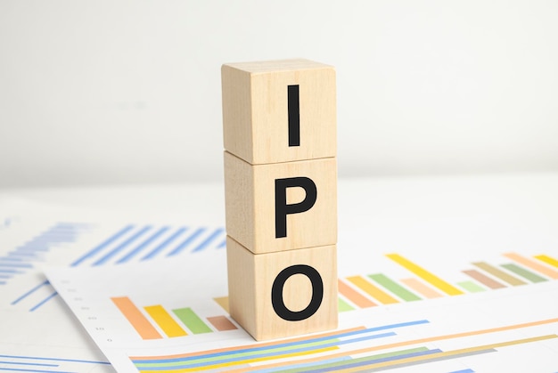 IPO word of wooden cube and charts on white background
