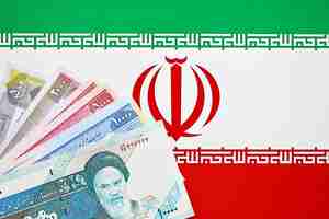 Photo iranian rial irr banknotes from iran on flag of islamic republic of iran