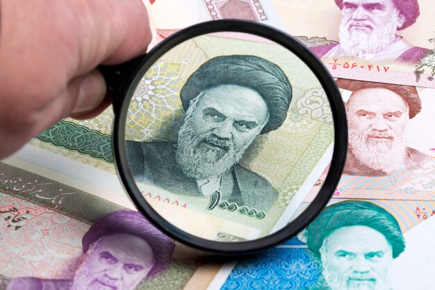 Iranian rial in a magnifying glass