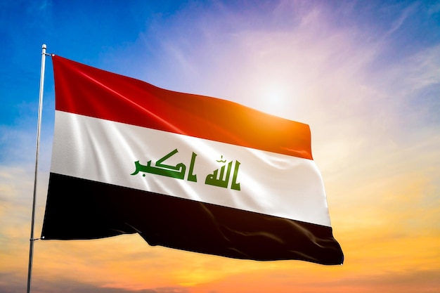 Iraq national flag waving in beautiful clouds.