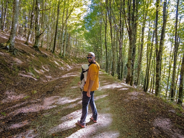 Irati forest or jungle in autumn, a young hiker at sunset on a path of pine trees. Ochagavia, northern Navarra in Spain