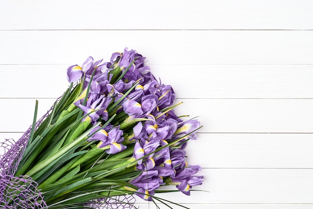 Iris bouquet on white wooden background