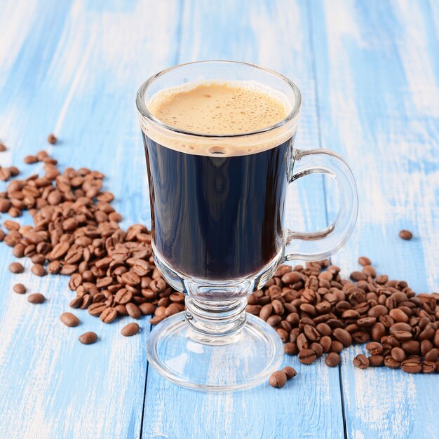 Irish coffee on a blue wooden background with coffee beans