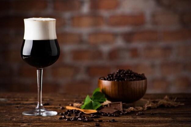 Irish coffee on wooden table and coffee beans Close up