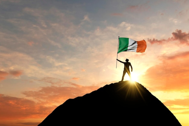 Irish flag being waved at the top of a mountain summit d rendering