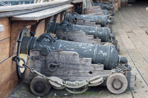 Iron cannon on sail ship