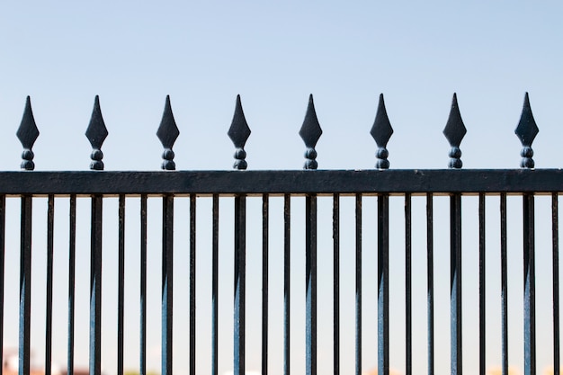 Photo iron forged fence over a blue sky