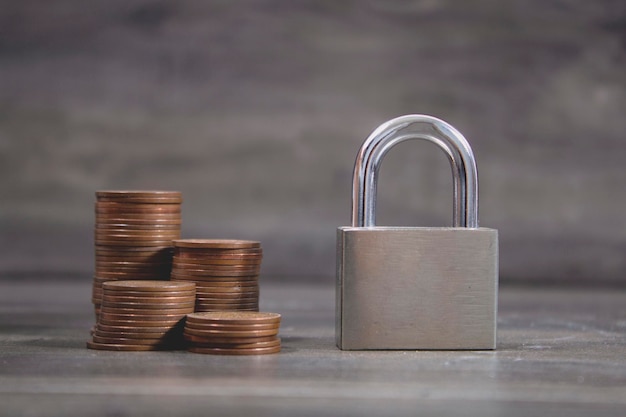 Iron lock and coins on the table.