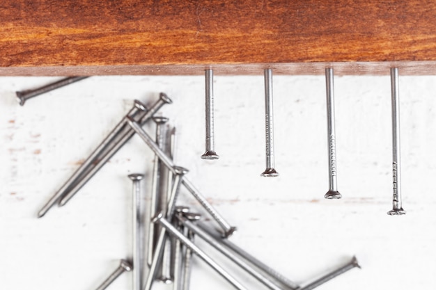 Iron nails on a wooden table