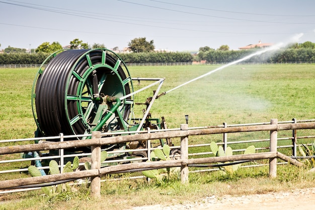 Irrigation operations in Italian country during a sunny day