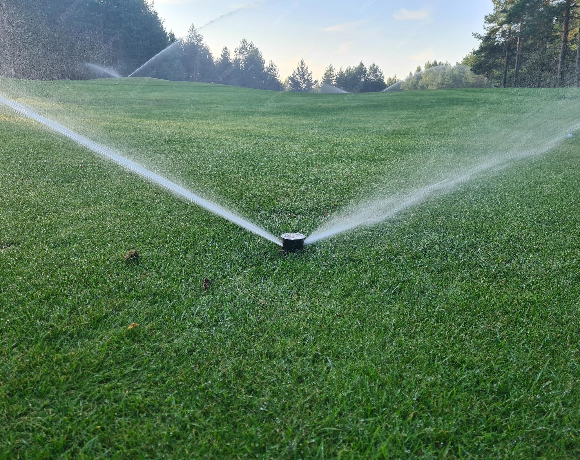 Premium Photo Irrigation system golf course water sprinkler