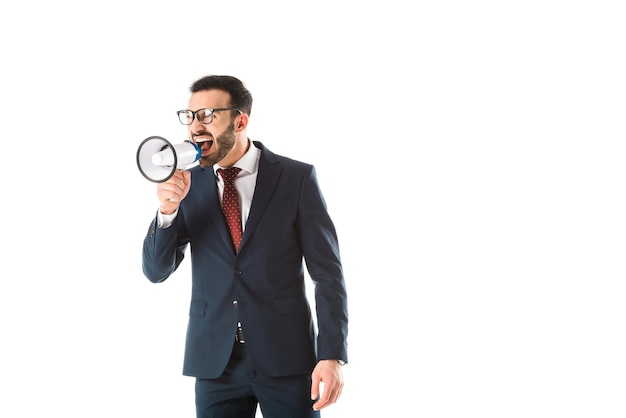 Irritated businessman quarreling in loudspeaker and looking away isolated on white