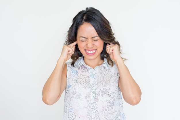 Irritated Young Asian Lady Covering Ears