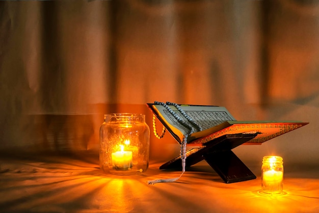 Photo islam holy book of muslims the quran is placed on a wooden standlight candles