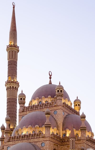 Islamic background with minarets of the al sahaba mosque in sharm el sheikh against ramadan dusk bright sky