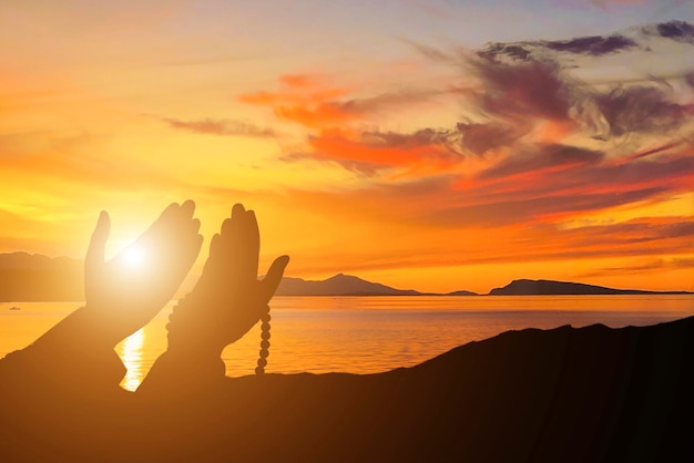 Photo islamic background with person praying with sunset