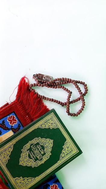 islamic concept The Islamic holy book Quran or kuran prayer beads and lantern on white background