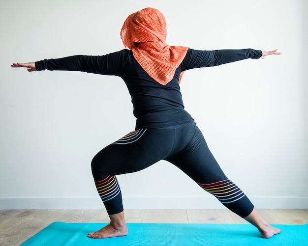 Islamic woman doing yoga in the room